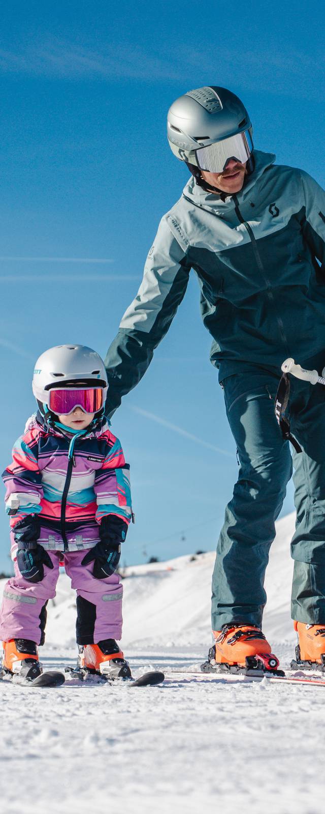 Kinder Ski in Saalfelden - Vater hilft seinem Kind beim Skifahren